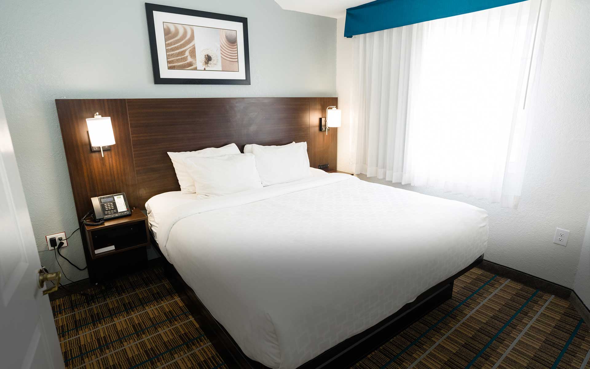 1 Queen Bed Bedroom Suite with full kitchen at Mainstay Suites Knoxville Airport, offering spacious and comfortable accommodations for extended stays